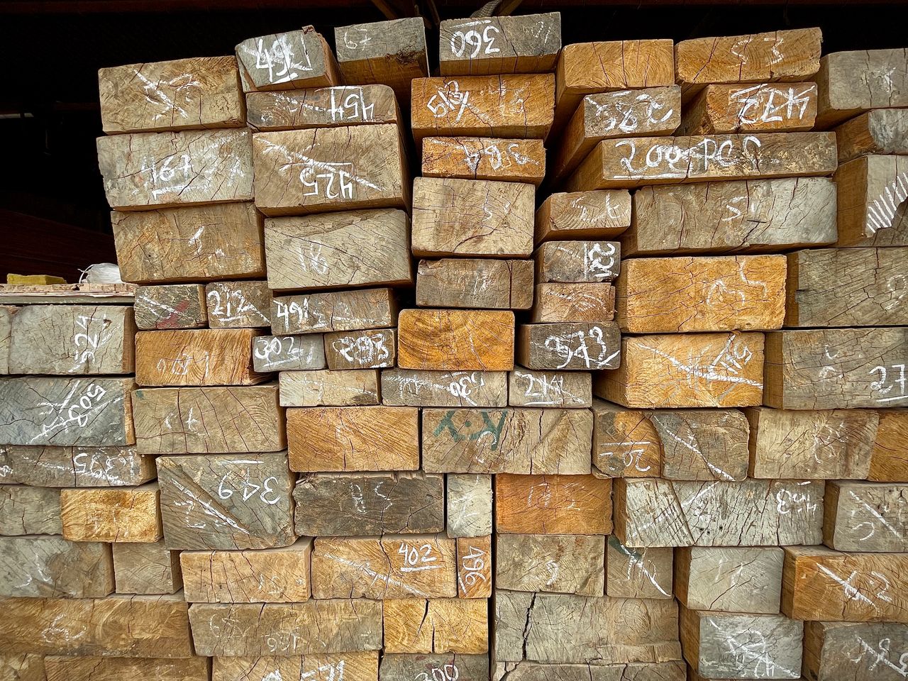 Mastering the First Impression: Your intriguing post title goes here Close-up of numbered wooden planks stacked in a warehouse, showcasing timber storage and organization.